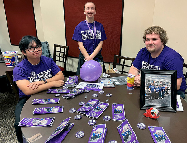 3 mga students at a table